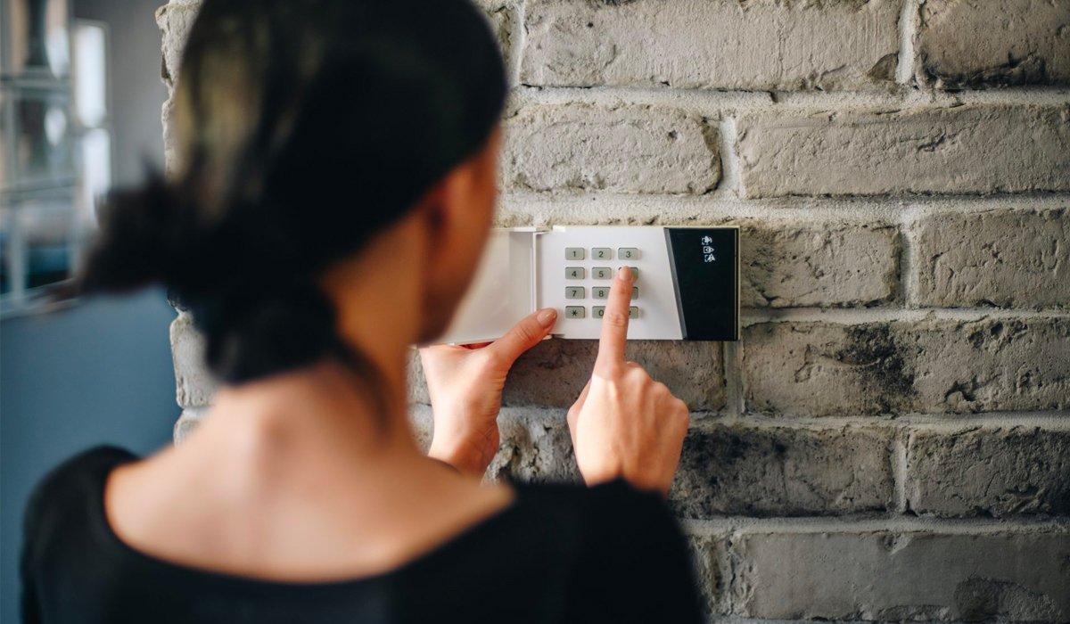 Girl-entering-code-on-alarm-keypad